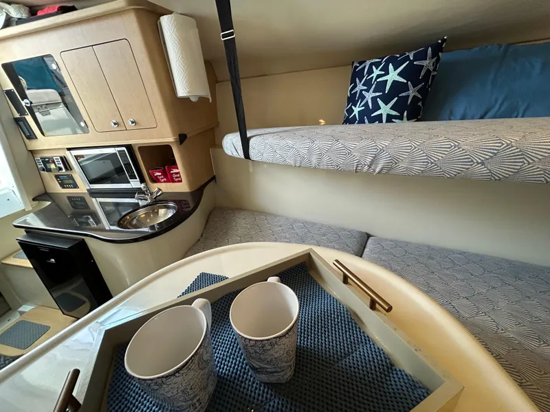 Slide: The Image of 2011 Hydra-Sports 3000 VX cabin interior with cozy seating and a small table. - 37