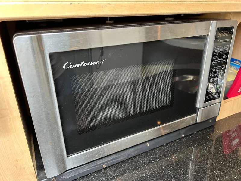 Slide: The Image of Stainless steel Contoure microwave oven in a wooden kitchen cabinet. - 38