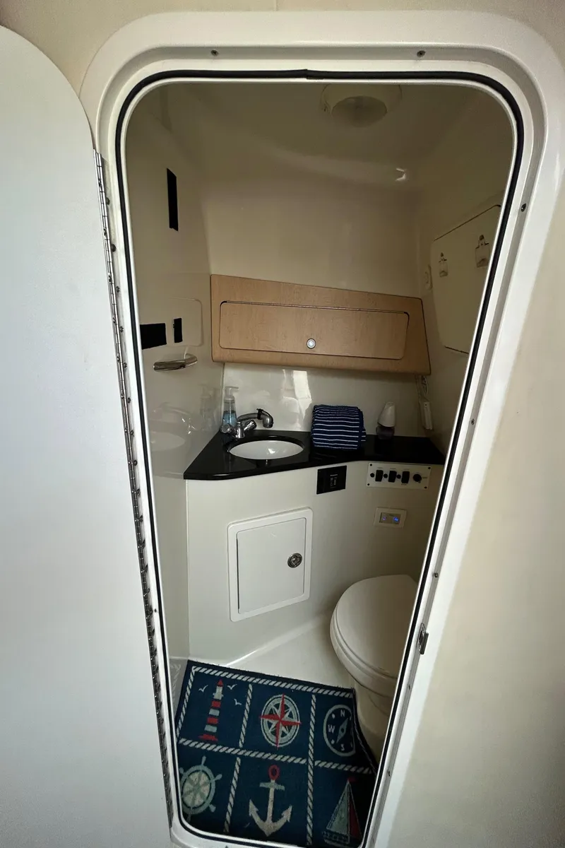 Slide: The Image of 2011 Hydra-Sports 3000 VX cabin interior with kitchenette, seating area, and bathroom. - 4