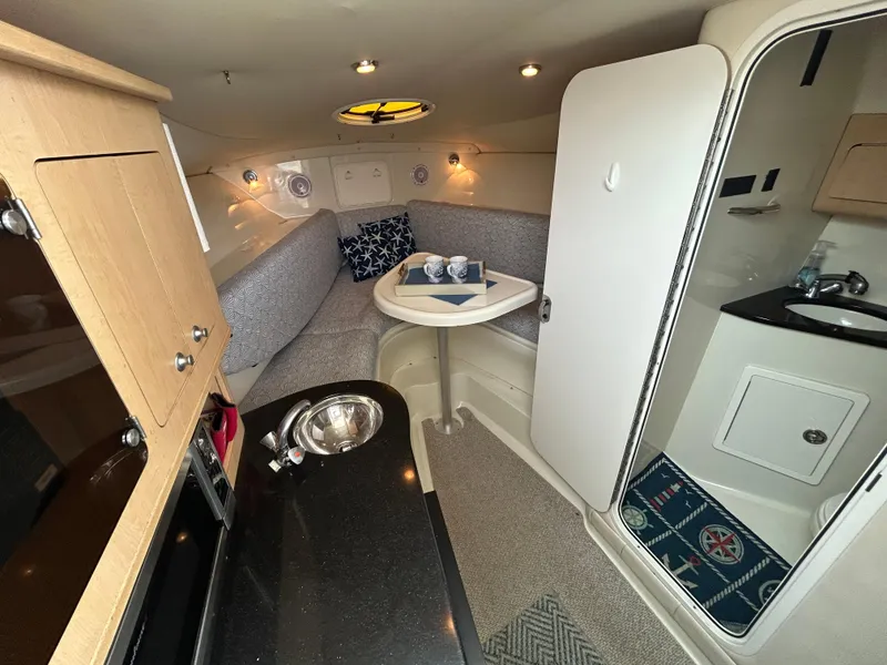 Slide: The Image of 2011 Hydra-Sports 3000 VX cabin interior with cozy seating and table setup. - 41