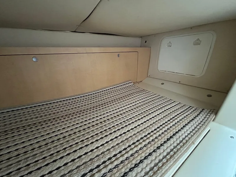 Slide: The Image of 2011 Hydra-Sports 3000 VX cabin interior with cushioned seating and storage compartments. - 42