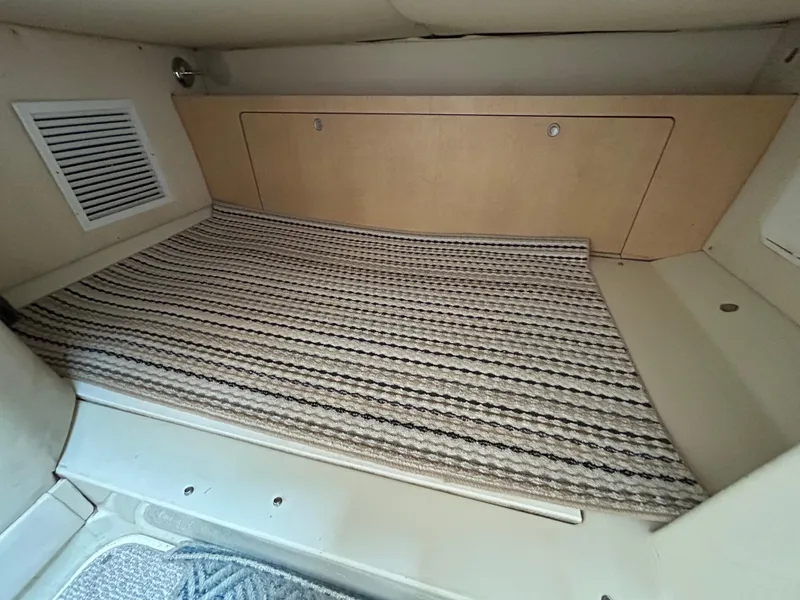 Slide: The Image of 2011 Hydra-Sports 3000 VX cabin interior with kitchenette, microwave, and cozy sleeping area. - 5