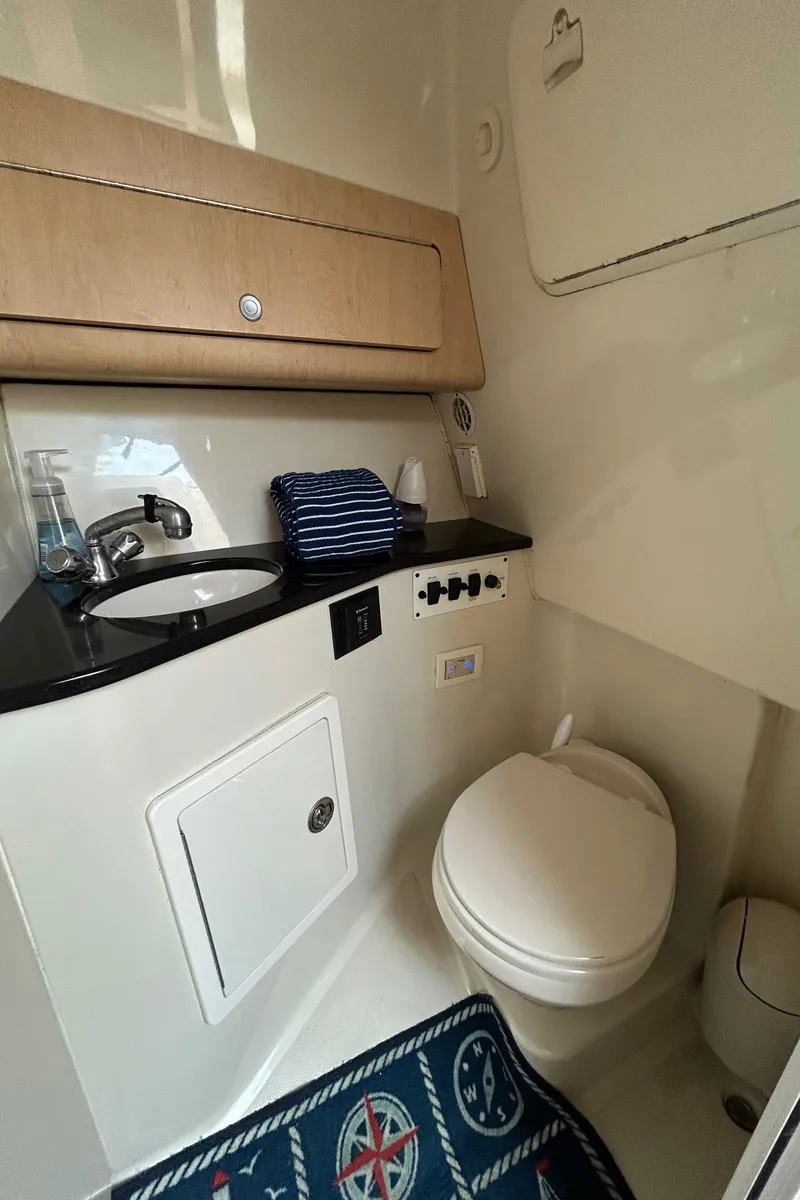 Slide: The Image of 2011 Hydra-Sports 3000 VX boat with cushioned deck, docked at marina. - 65