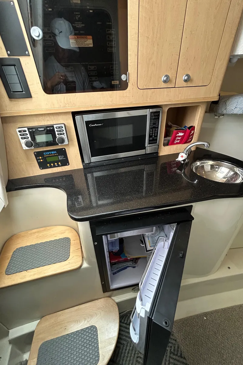 Slide: The Image of 2011 Hydra-Sports 3000 VX boat docked on a sunny day, surrounded by calm water. - 68