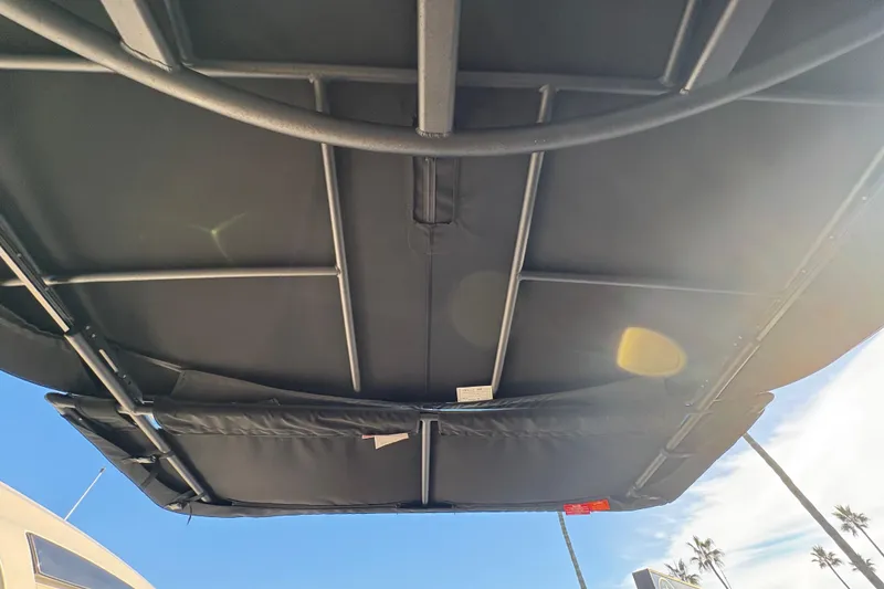 Slide: The Image of 2026 Sea Ray SLX 280 Outboard boat canopy viewed from below, sunny day. - 10