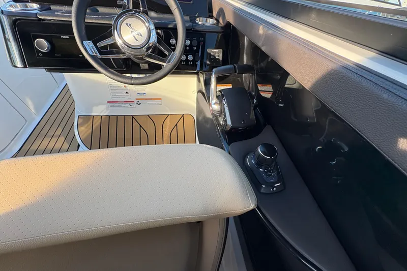 Slide: The Image of 2026 Sea Ray SLX 280 Outboard helm with steering wheel and controls. - 13