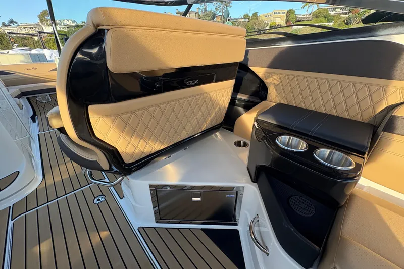 Slide: The Image of Luxurious interior of 2026 Sea Ray SLX 280 Outboard with elegant seating and cup holders. - 15