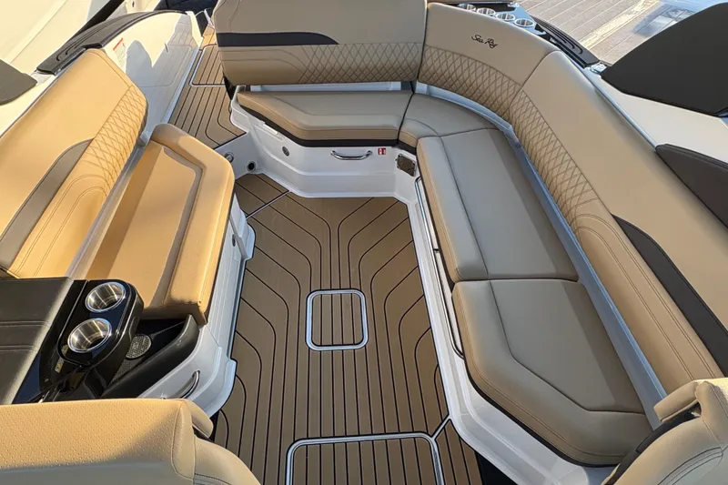 Slide: The Image of Luxurious interior of 2026 Sea Ray SLX 280 Outboard with tan seating and wood flooring. - 9