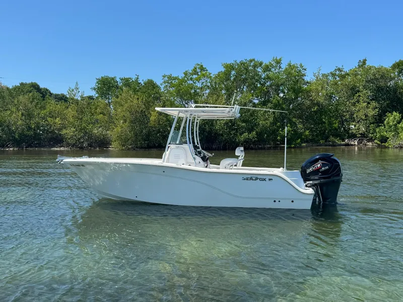 The Image of 2011 Sea Fox 226 Commander boat in clear water, surrounded by lush greenery. - 0