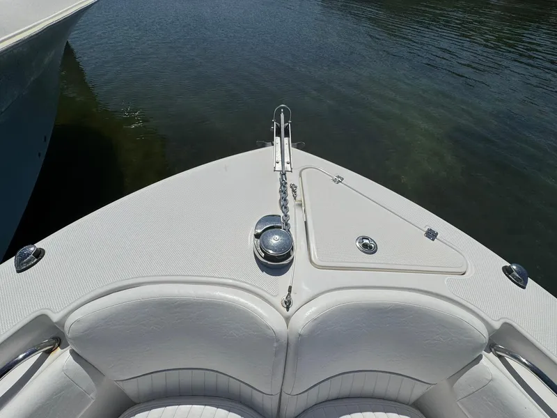 Slide: The Image of Bow of 2011 Sea Fox 226 Commander boat with anchor and seating, on calm water. - 12