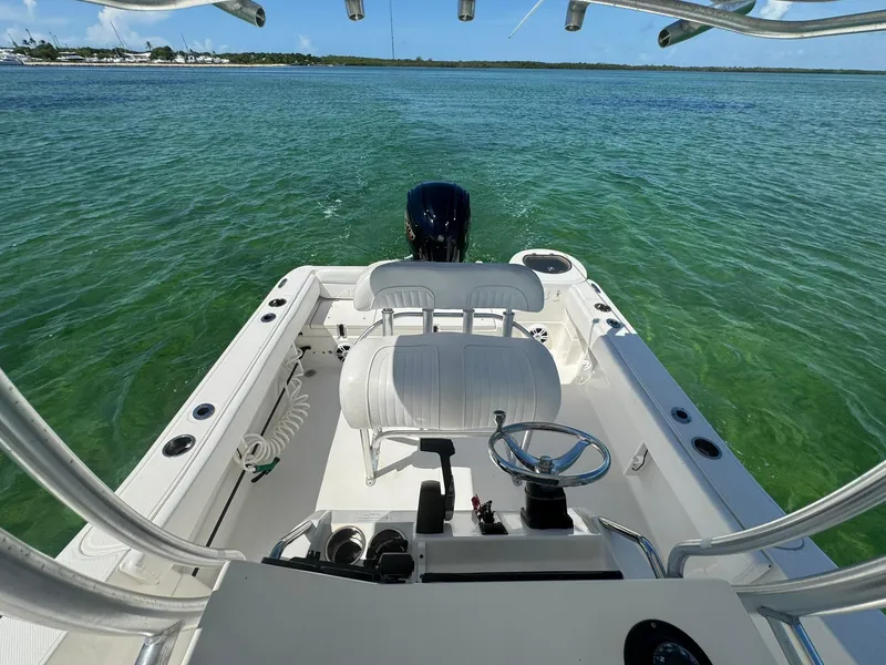 Slide: The Image of 2011 Sea Fox 226 Commander boat on clear water, featuring helm and seating area. - 17