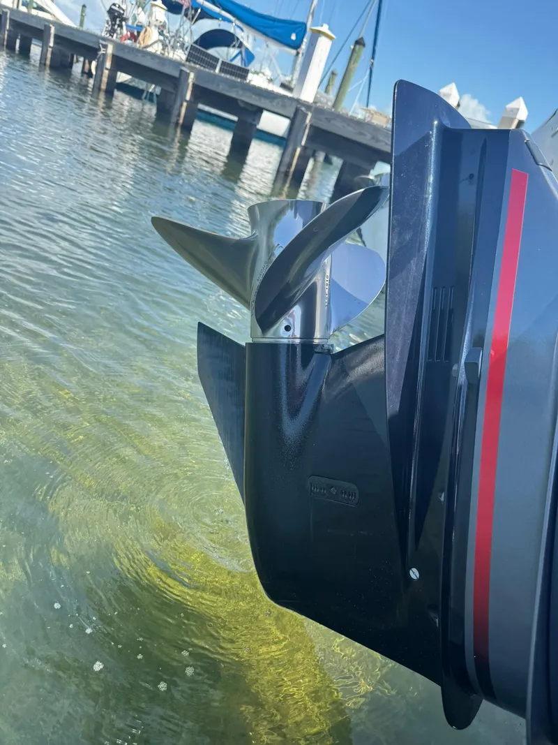 Slide: The Image of Outboard motor of a 2011 Sea Fox 226 Commander boat near a dock. - 19