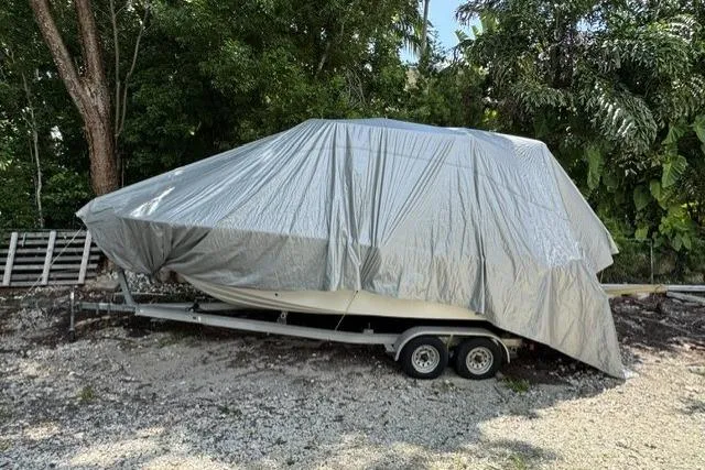 Slide: The Image of Covered 2011 Sea Fox 226 Commander boat on trailer, surrounded by trees. - 25