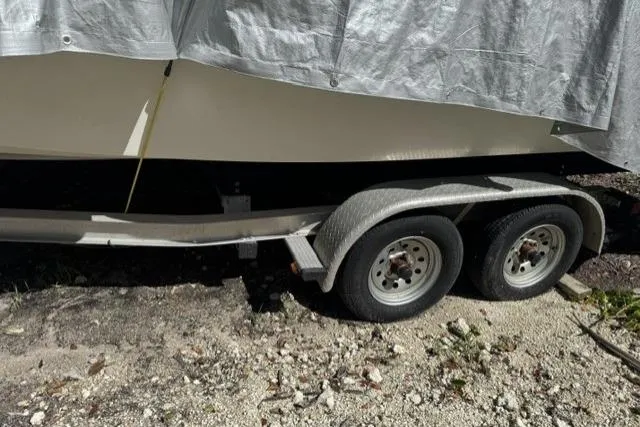 Slide: The Image of 2011 Sea Fox 226 Commander boat on trailer, partially covered with tarp. - 26