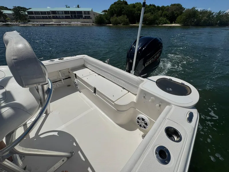 Slide: The Image of 2011 Sea Fox 226 Commander boat interior with seating and outboard motor on the water. - 5