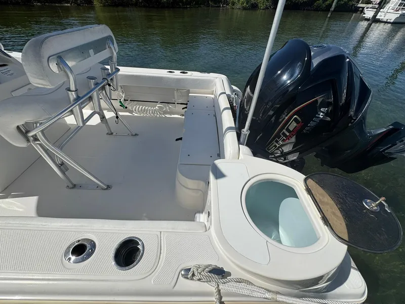Slide: The Image of 2011 Sea Fox 226 Commander boat interior with Yamaha engine, featuring seating and storage. - 6