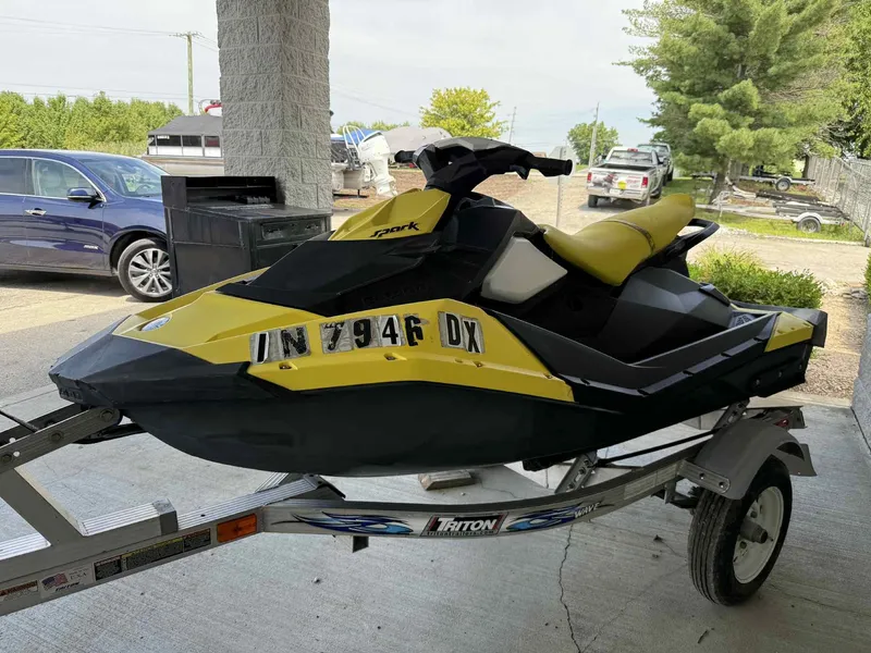 The Image of 2016 Sea-Doo Spark 2up jet ski on trailer, yellow and black design. - 0
