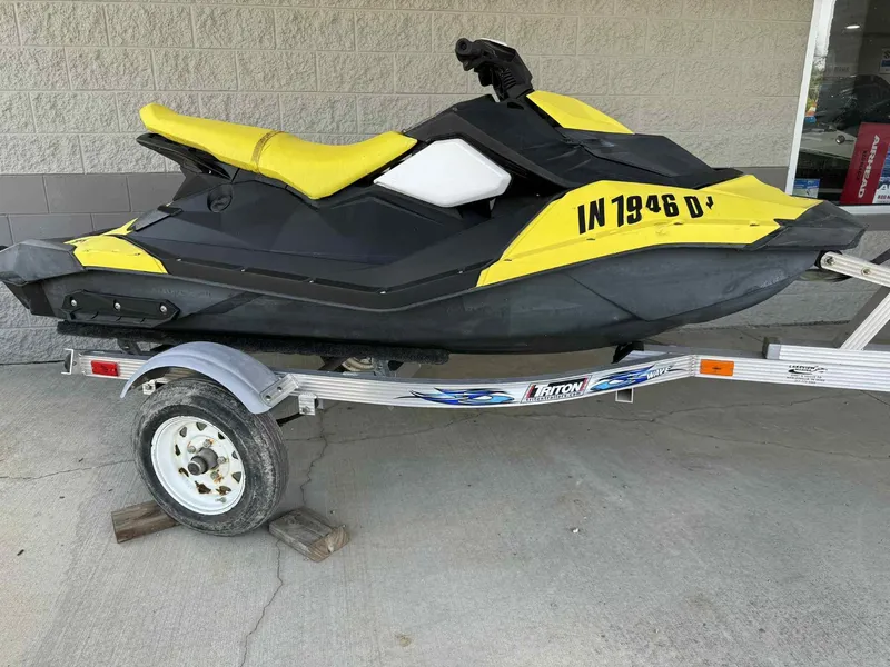 Slide: The Image of 2016 Sea-Doo Spark 2up jet ski on trailer, yellow and black design. - 2