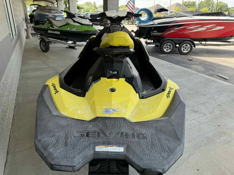 Slide: The Image of 2016 Sea-Doo Spark 2up in yellow, parked with other watercraft. - 6