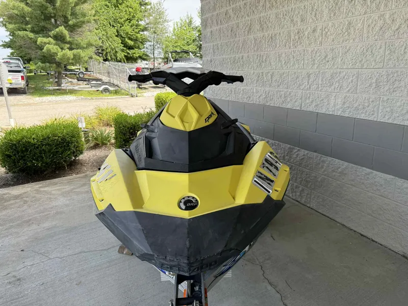 Slide: The Image of 2016 Sea-Doo Spark 2up jet ski in yellow, parked outdoors. - 8