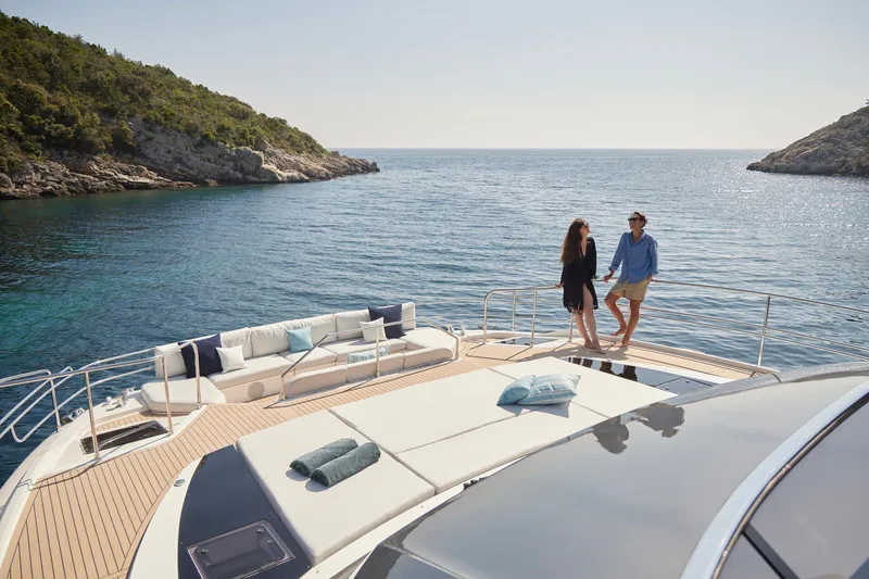 Slide: The Image of Couple enjoying a sunny day on a 2026 Prestige M8 yacht, near a scenic coastline. - 10