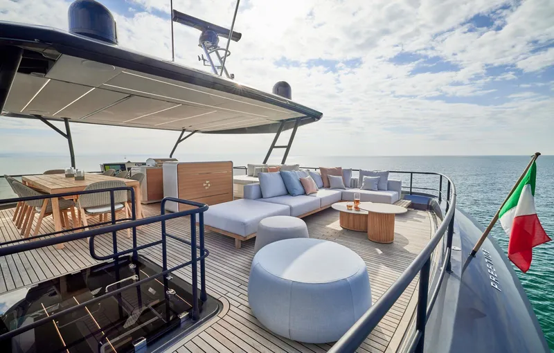Slide: The Image of Luxurious 2026 Prestige M8 yacht deck with seating, dining area, and ocean view. - 11