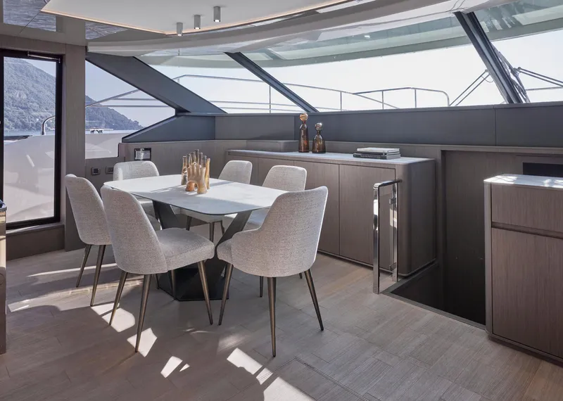 Slide: The Image of Luxurious dining area on 2026 Prestige M8 yacht with modern decor and panoramic views. - 24