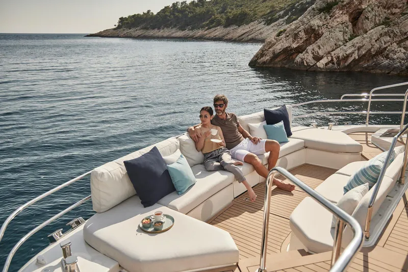 Slide: The Image of Couple relaxing on a 2026 Prestige M8 yacht, enjoying scenic ocean views. - 4