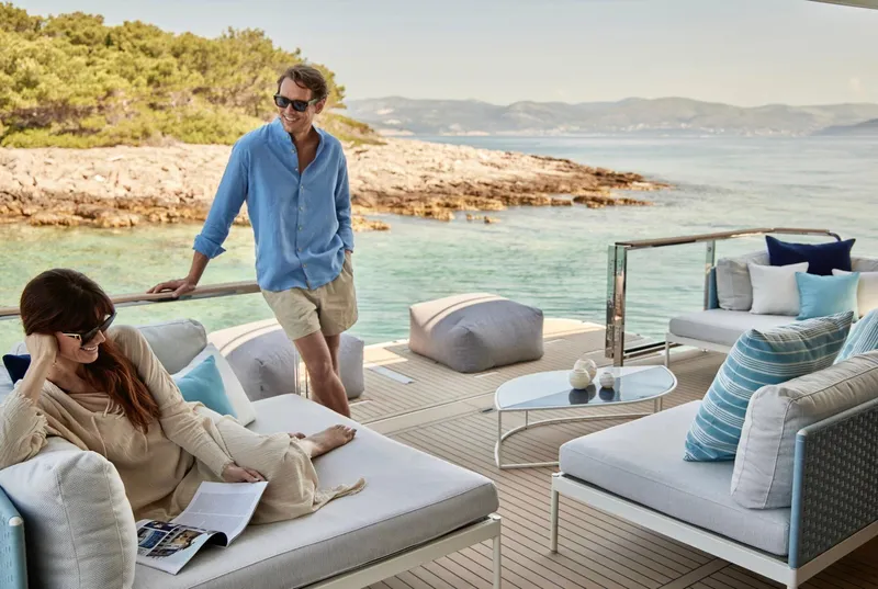 Slide: The Image of Couple relaxing on a Prestige M8 yacht, enjoying a scenic coastal view. - 5