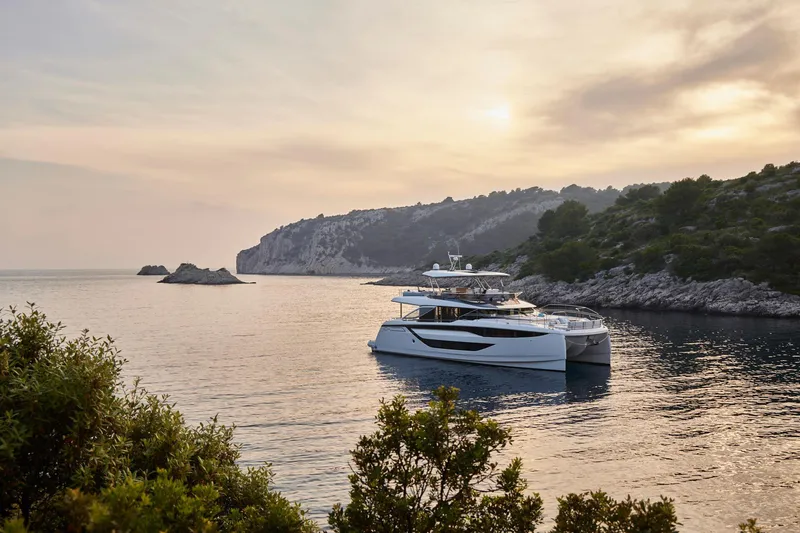 Slide: The Image of Luxury Prestige M8 yacht anchored in serene coastal waters at sunset, 2026 model. - 37
