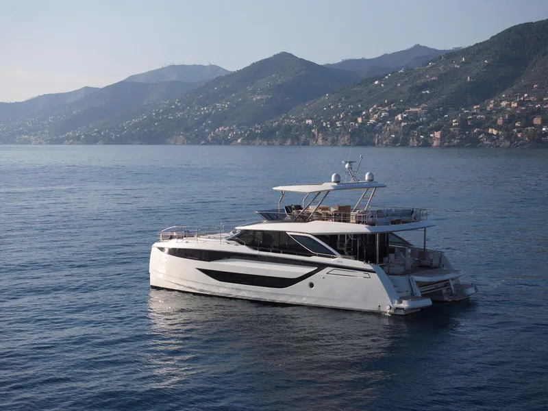 Slide: The Image of Luxury Prestige M8 yacht on serene waters with scenic mountain backdrop, 2026 model. - 8