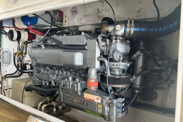 Slide: The Image of Engine compartment of a 2001 Legacy Boat 28 Express, featuring a Yanmar marine engine. - 16