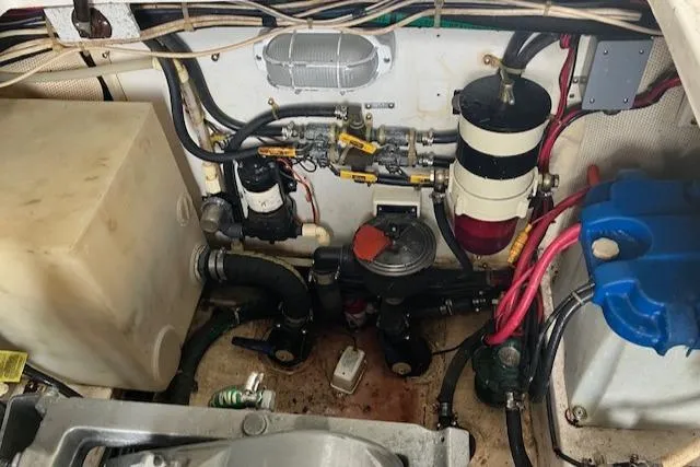 Slide: The Image of Engine compartment of a 2001 Legacy Boat 28 Express, showcasing various mechanical components. - 17