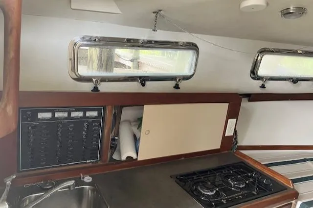 Slide: The Image of Interior of 2001 Legacy Boat 28 Express, featuring kitchen area with stove and sink. - 18
