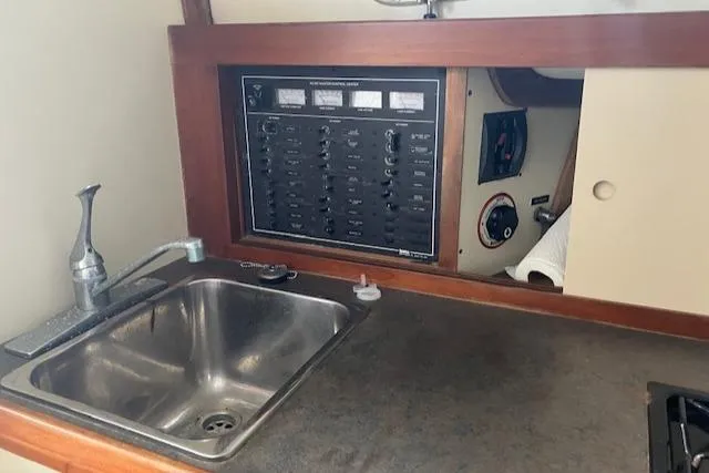 Slide: The Image of 2001 Legacy Boat 28 Express interior with sink and control panel. - 19