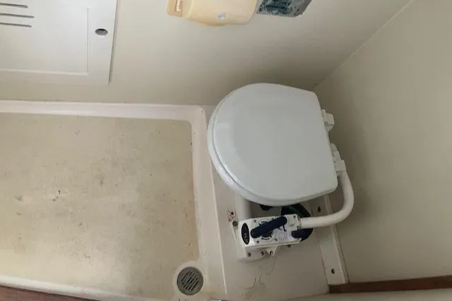 Slide: The Image of 2001 Legacy Boat 28 Express bathroom with compact marine toilet. - 22