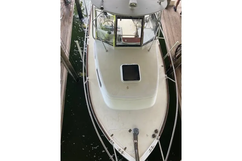 Slide: The Image of 2001 Legacy Boat 28 Express docked, aerial view showing deck and cabin. - 30