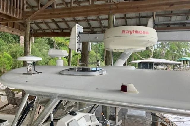 Slide: The Image of 2001 Legacy Boat 28 Express with Raytheon radar, docked under wooden shelter. - 6