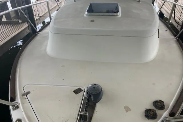 Slide: The Image of 2001 Legacy Boat 28 Express, docked, showcasing spacious deck and sleek design. - 7