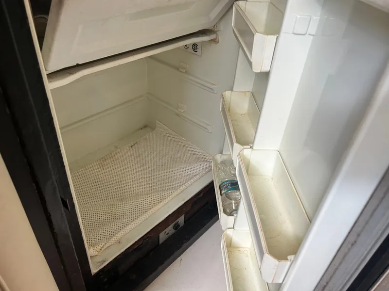 Slide: The Image of Empty refrigerator inside 1999 Wellcraft 330 Coastal boat. - 33
