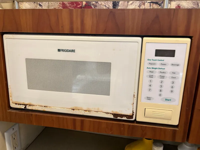 Slide: The Image of Frigidaire microwave in a Wellcraft 330 Coastal boat, 1999 model, with wood paneling. - 35