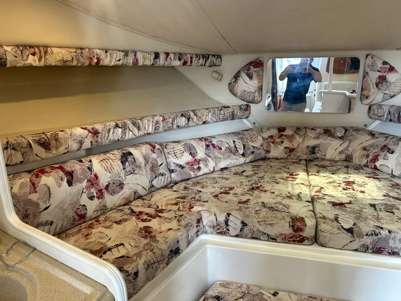 Slide: The Image of 1999 Wellcraft 330 Coastal cabin interior with floral upholstery and cozy seating area. - 40