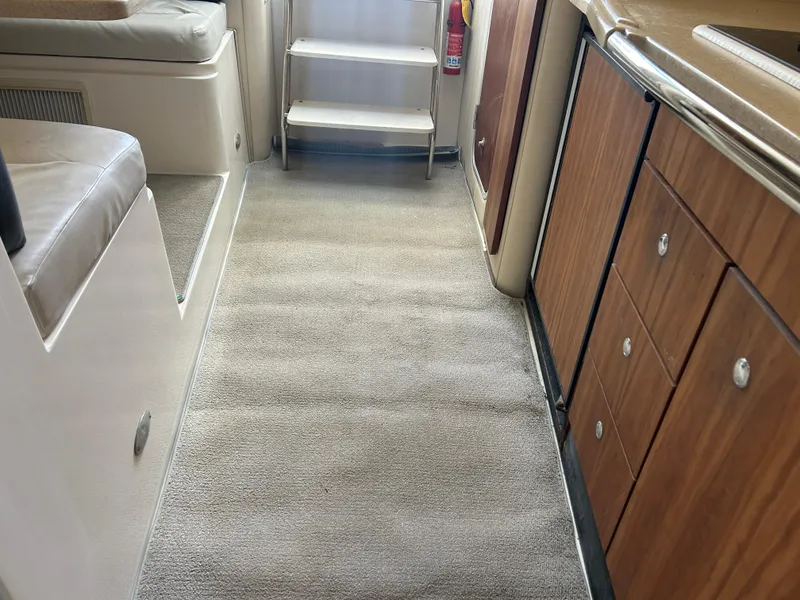 Slide: The Image of Interior of 1999 Wellcraft 330 Coastal boat with carpeted floor and wooden cabinets. - 42