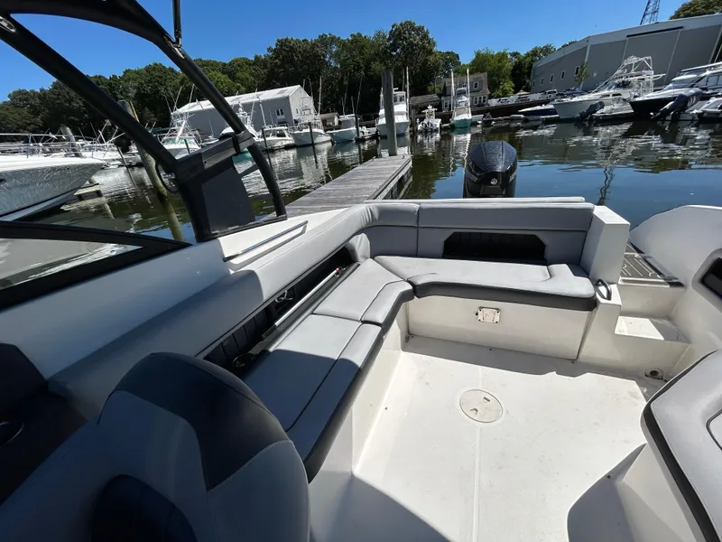 Slide: The Image of 2019 Rinker Q5 OB boat docked with Mercury outboard motor, sunny day. - 17