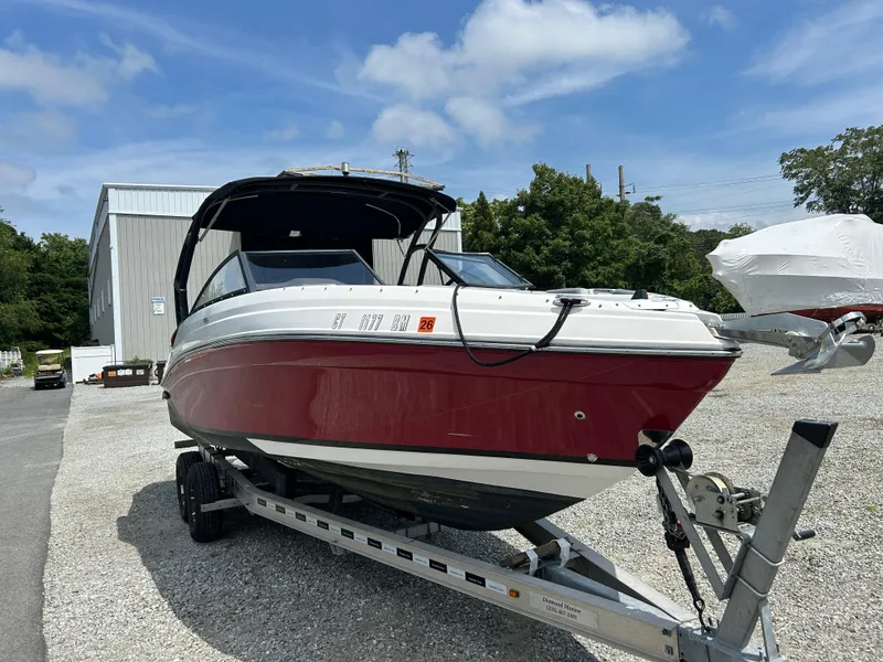Slide: The Image of Aerial view of 2019 Rinker Q5 OB boat with black canopy on water. - 6