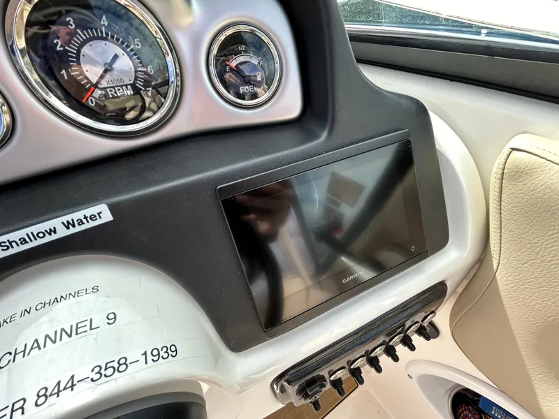 Slide: The Image of Dashboard of 2022 NauticStar 243 DC boat with gauges and touchscreen display. - 10