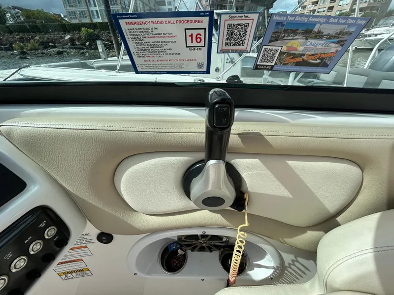 Slide: The Image of Interior of 2022 NauticStar 243 DC boat with control panel and emergency radio instructions. - 11