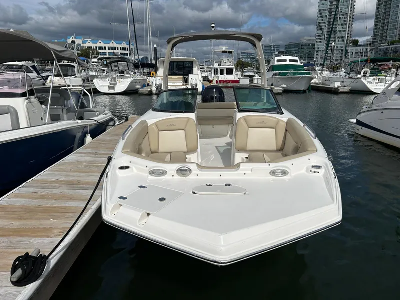 Slide: The Image of 2022 NauticStar 243 DC boat docked at a marina with other vessels. - 3