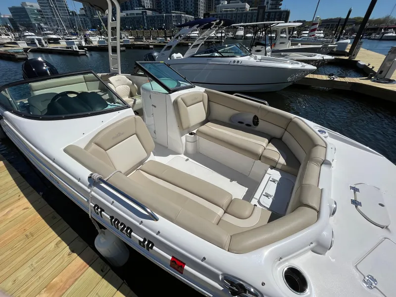 Slide: The Image of 2022 NauticStar 243 DC boat with beige seating at a marina dock. - 6