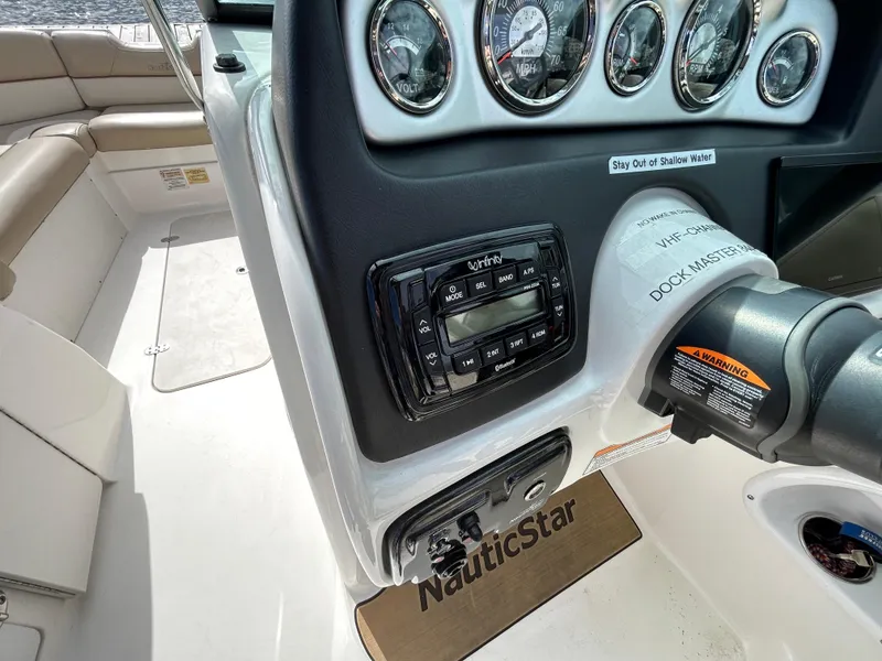 Slide: The Image of 2022 NauticStar 243 DC boat dashboard with gauges and controls. - 8